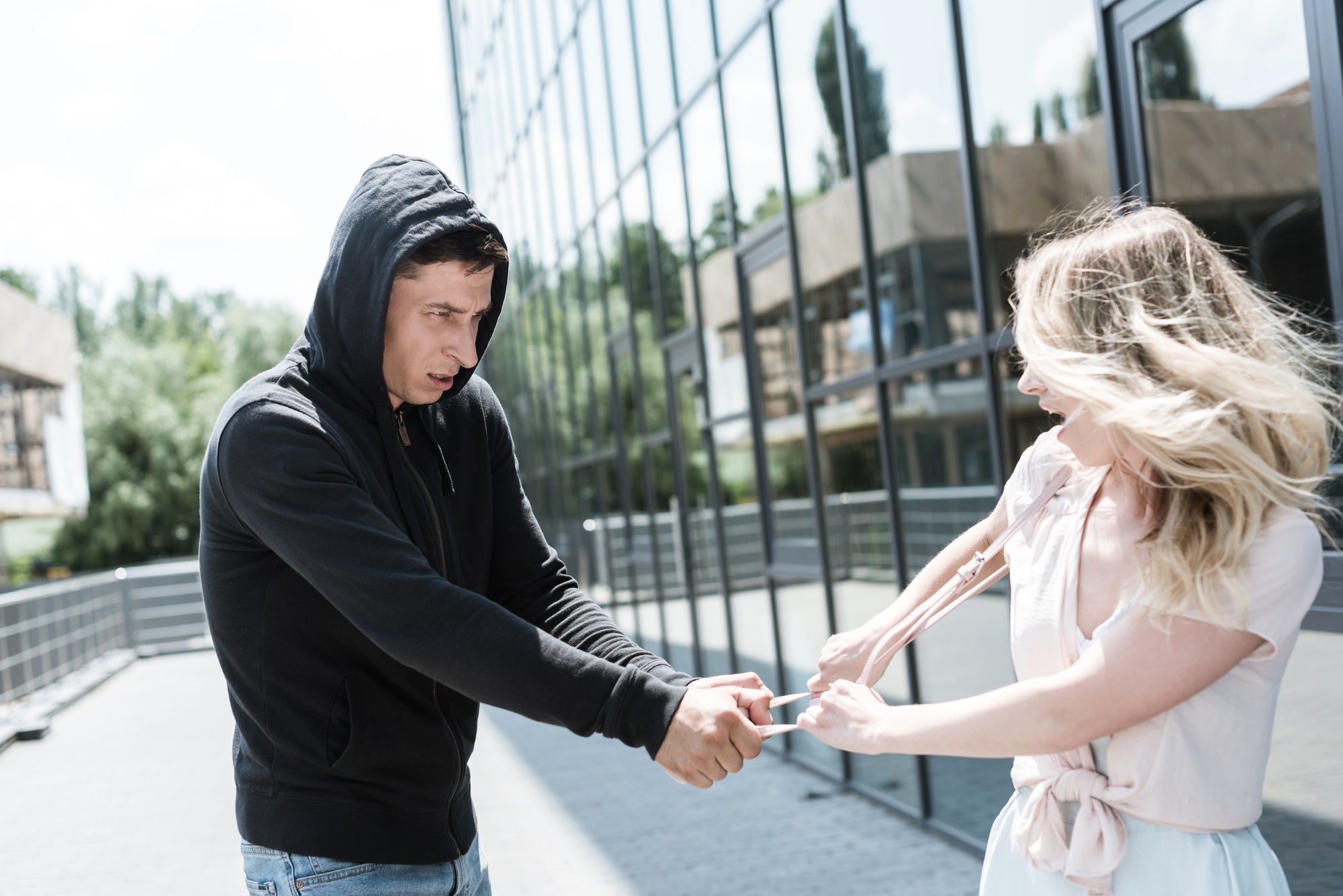 Man taking woman's purse